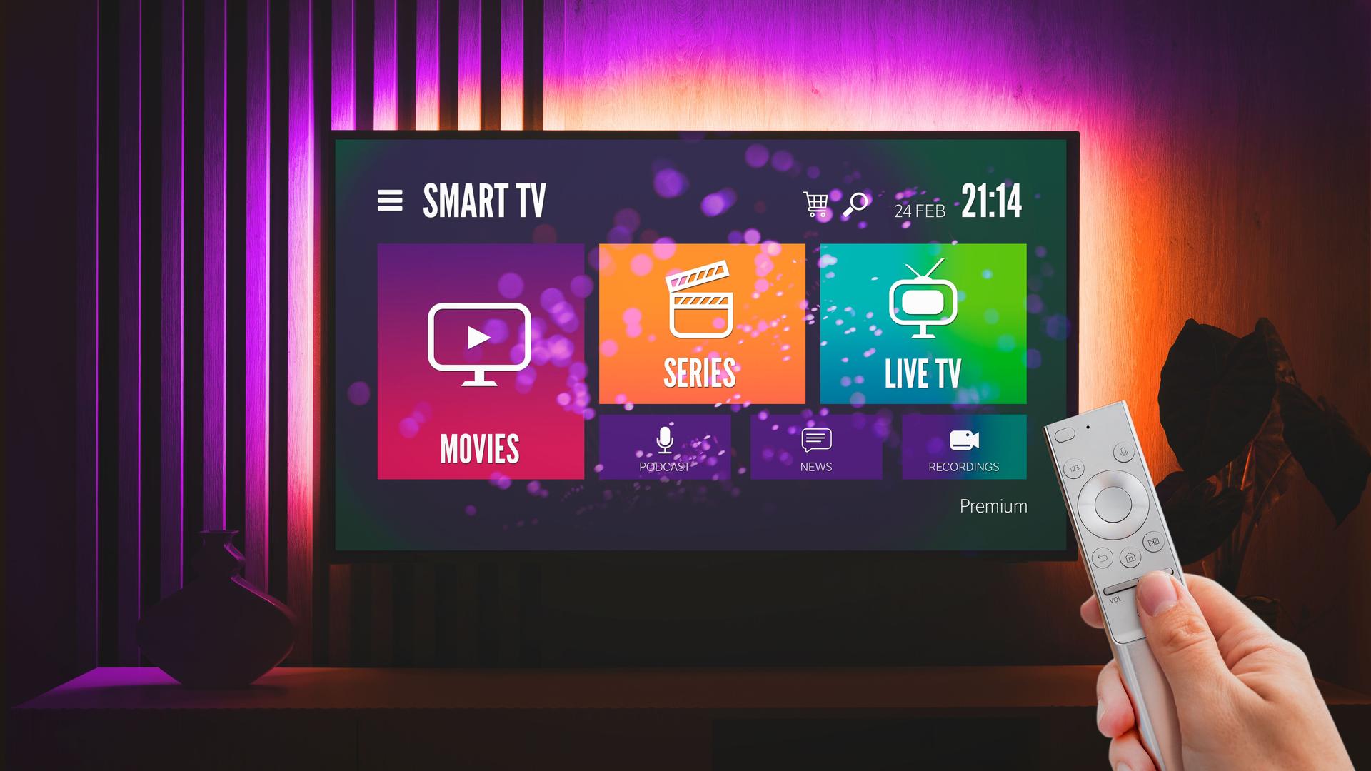 Man watching TV, remote control in hand